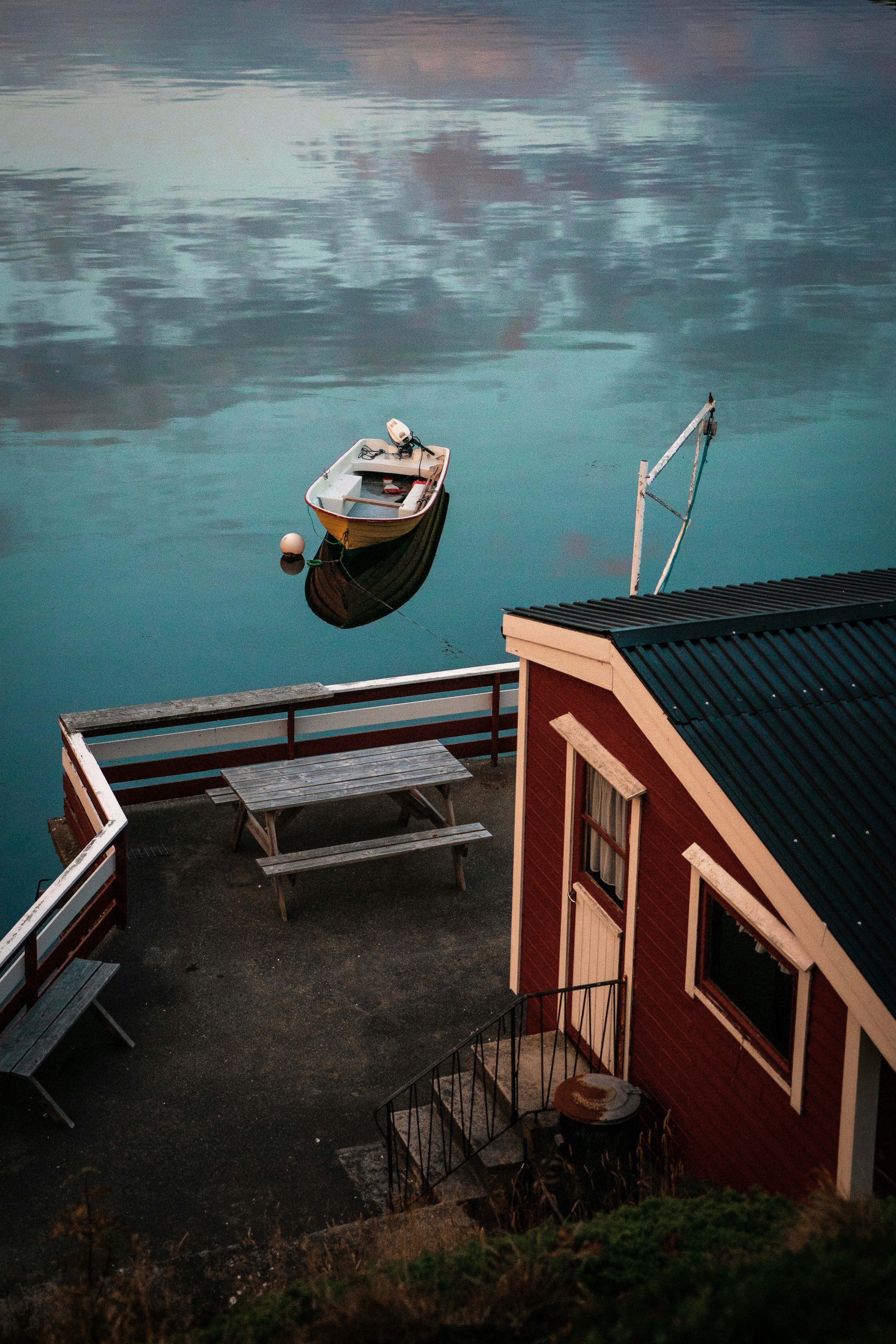 brown and white wooden house beside body of water during daytime